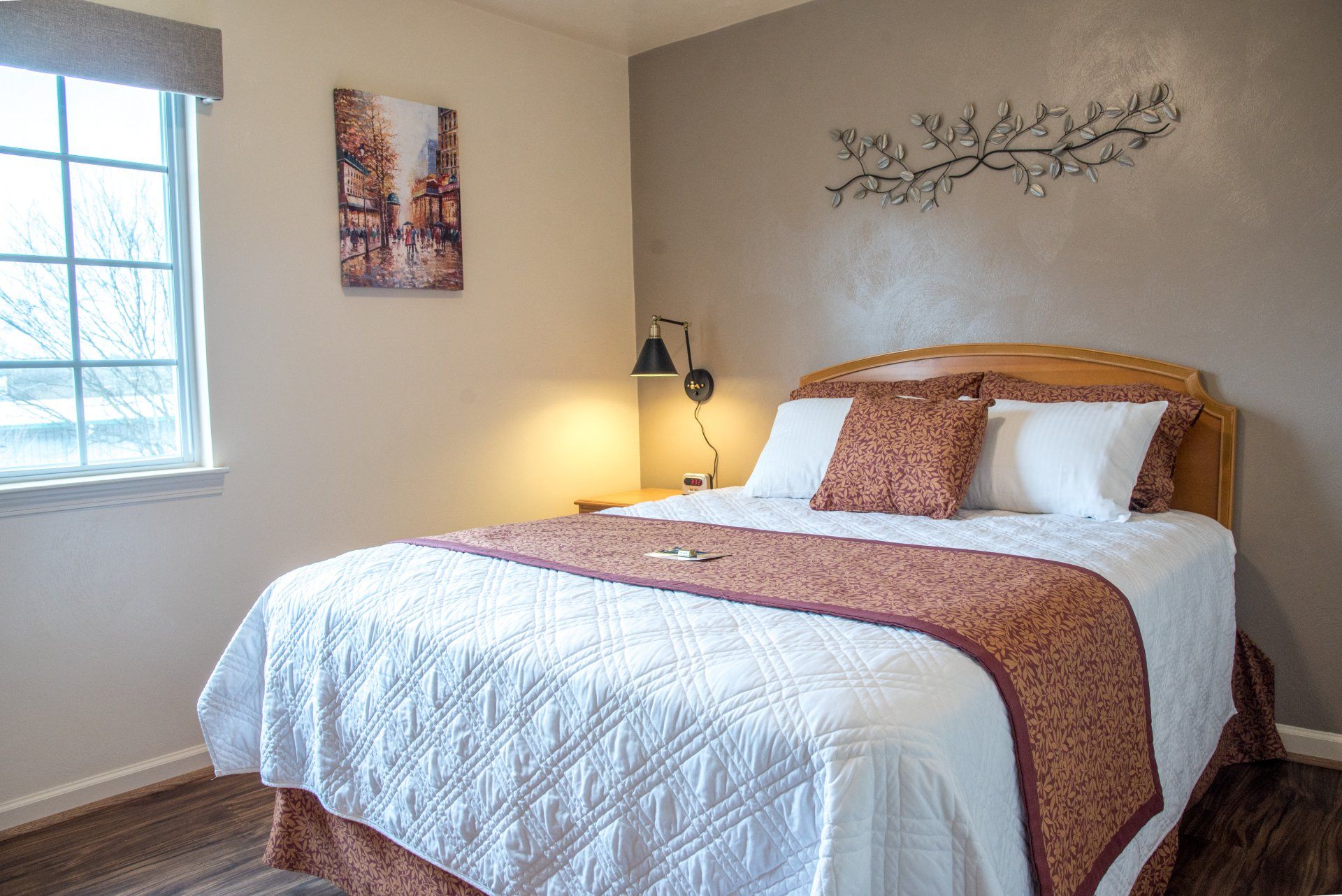 A bedroom with a king size bed and a window.