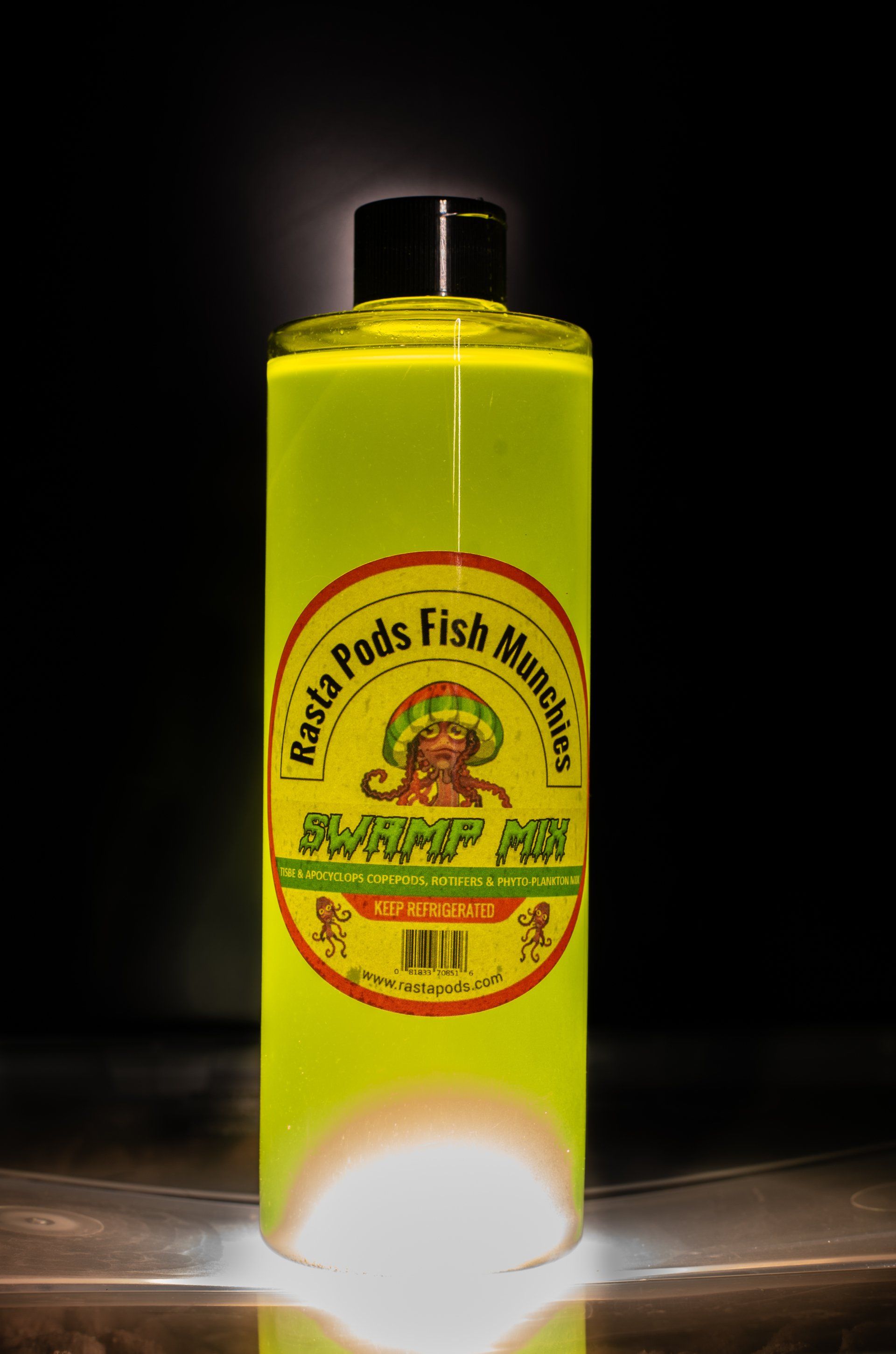 A bottle of yellow liquid with a monkey on the label is sitting on a table.
