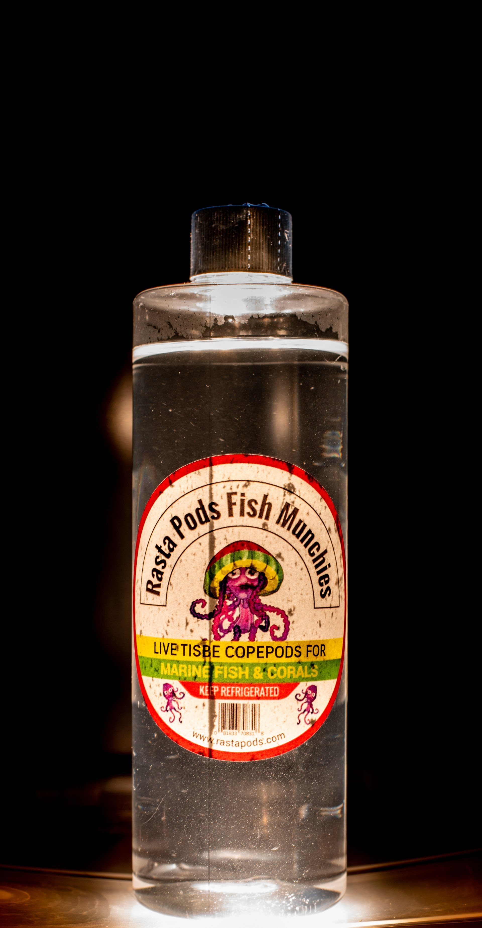 A bottle of liquid is sitting on a table.