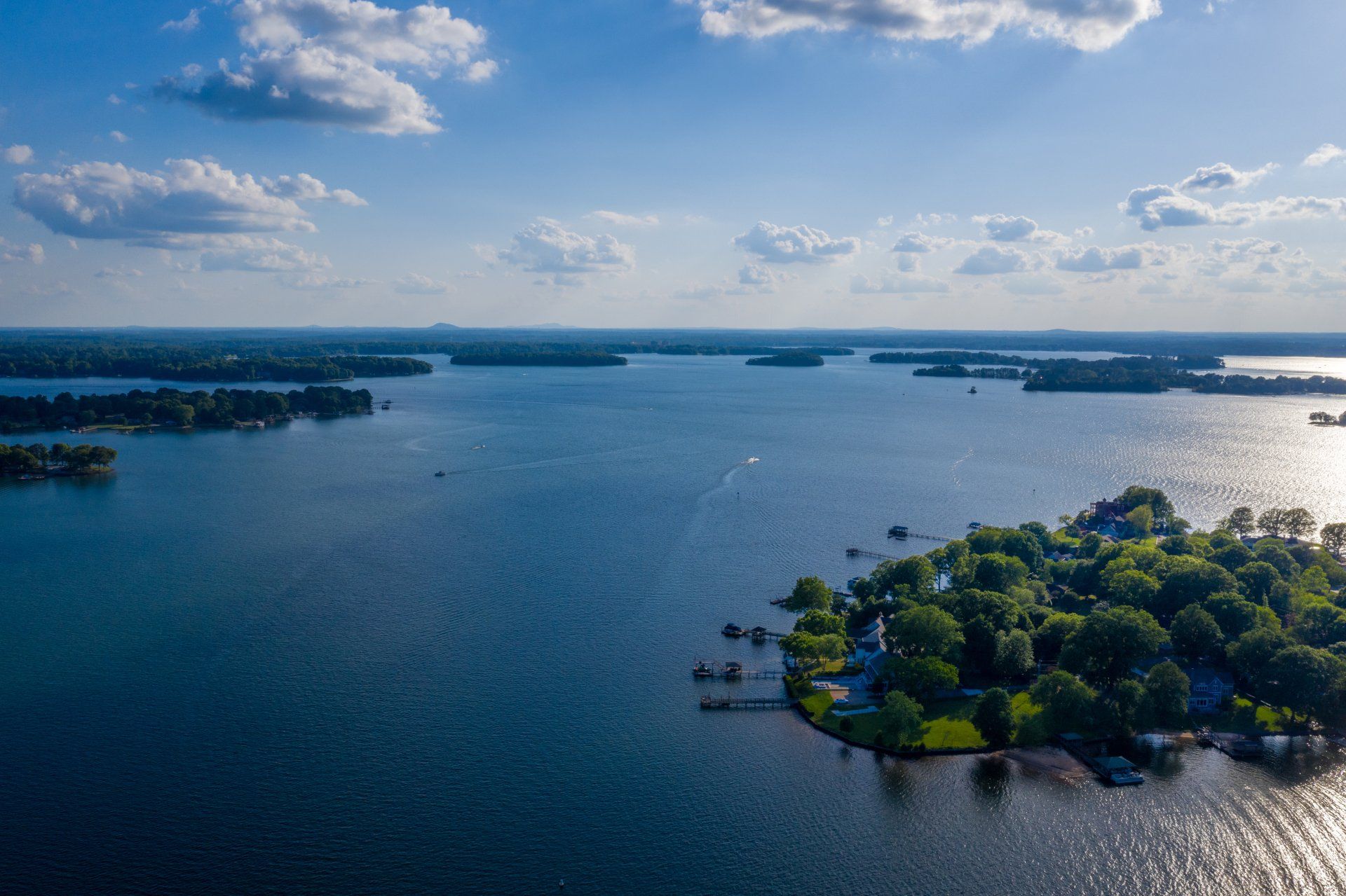 An aerial view of a lake with a small island in the middle.