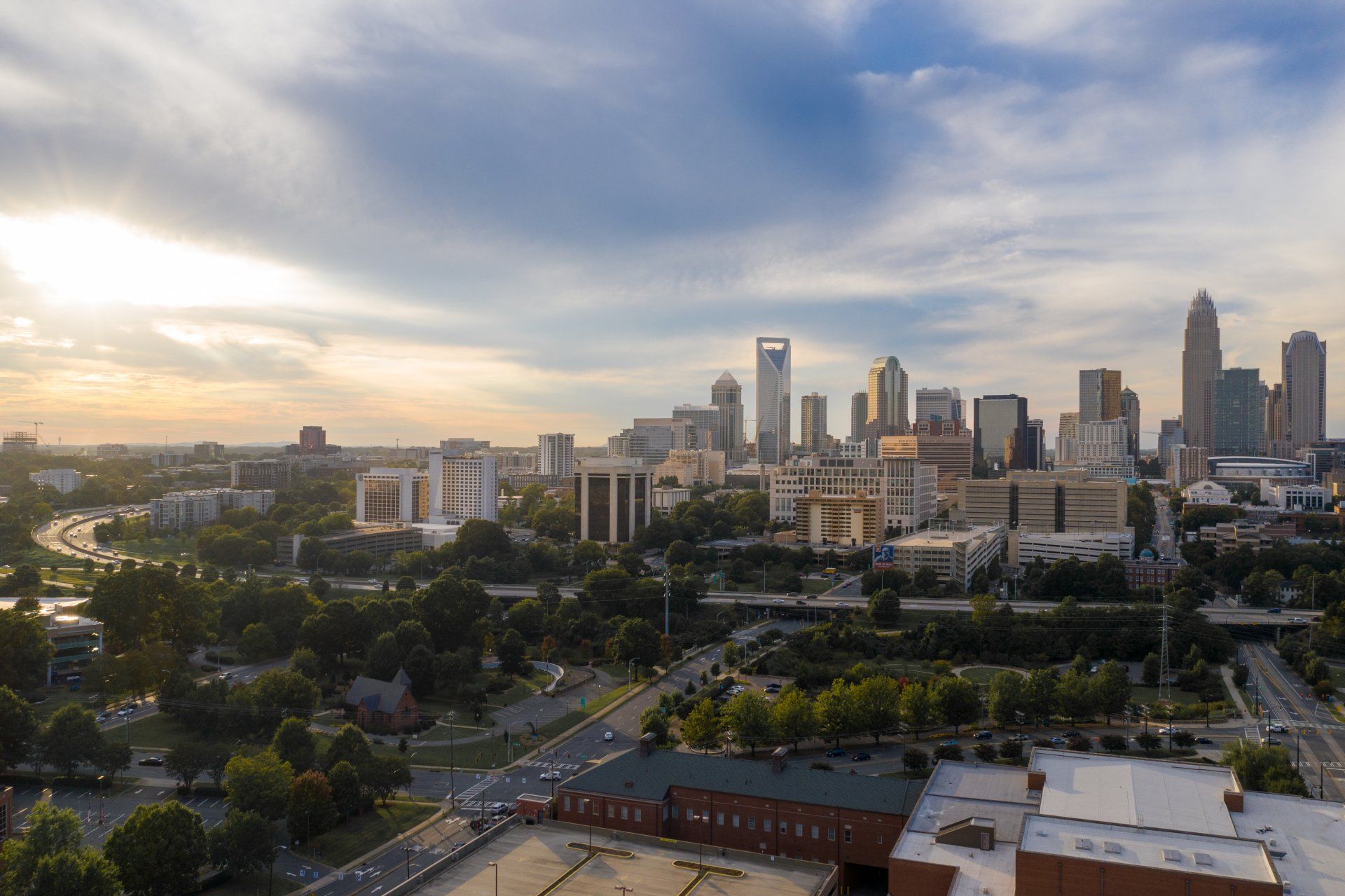 An aerial view of a city skyline at sunset.