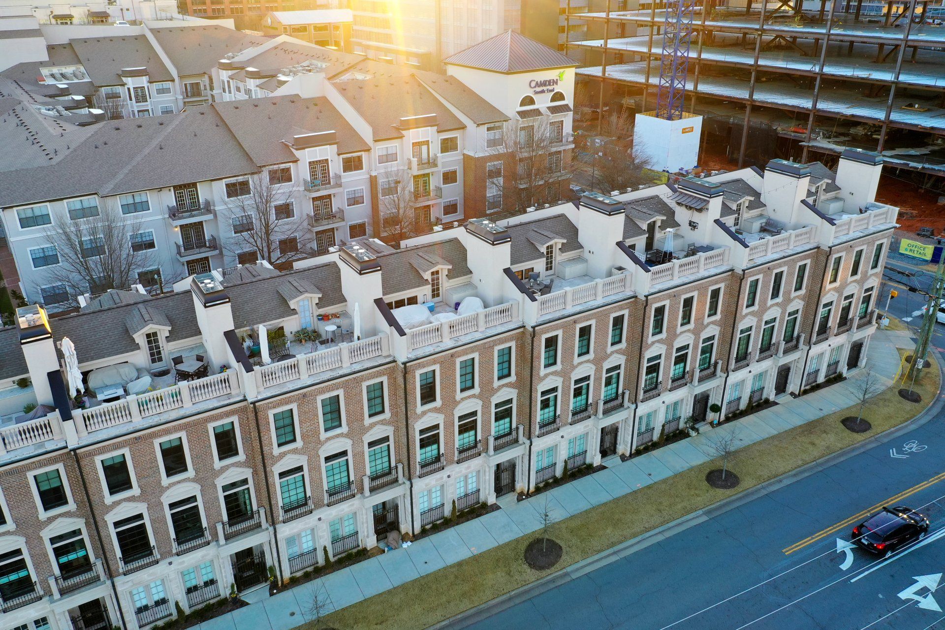 An aerial view of a row of apartment buildings in a city.