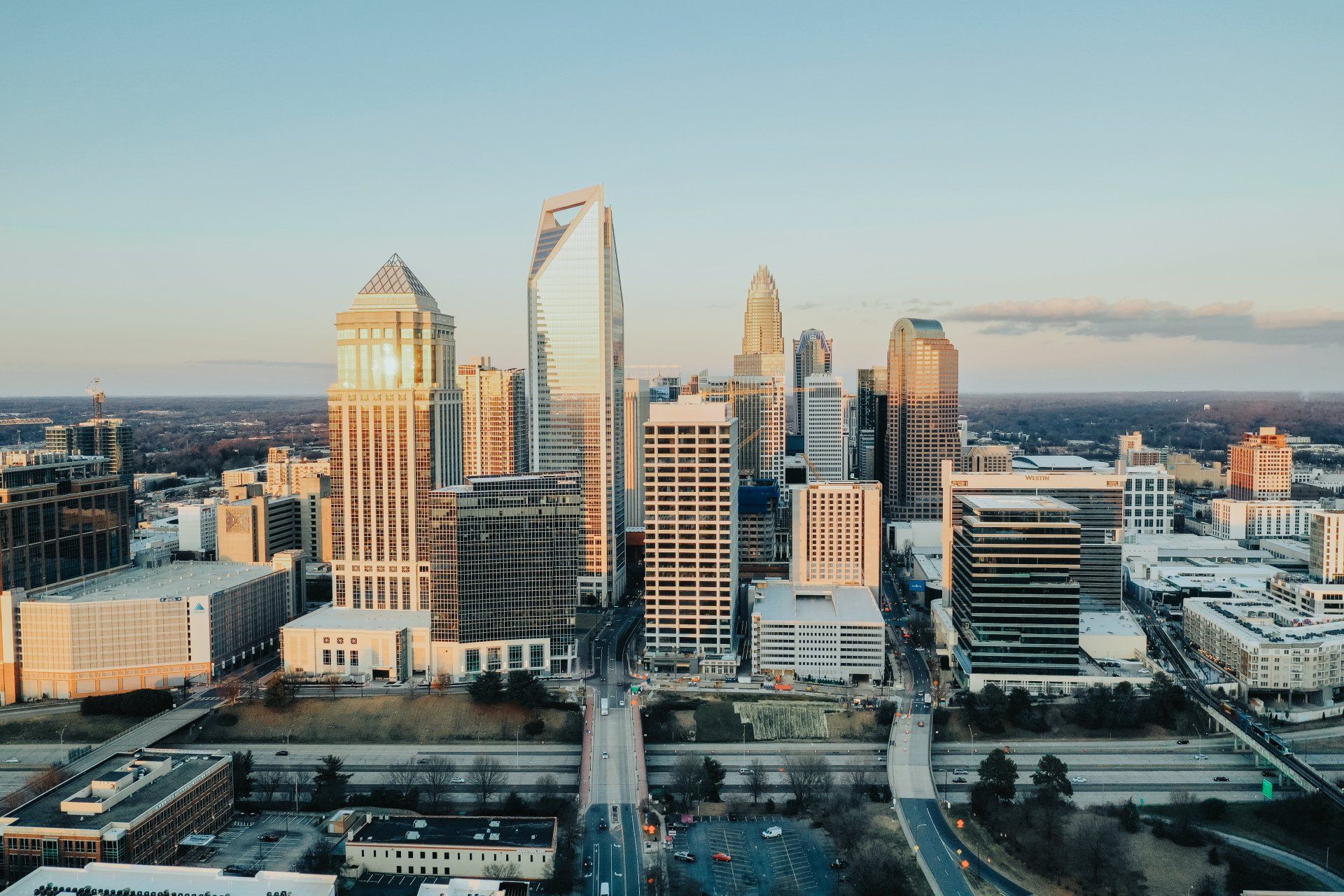 An aerial view of a city skyline at sunset.