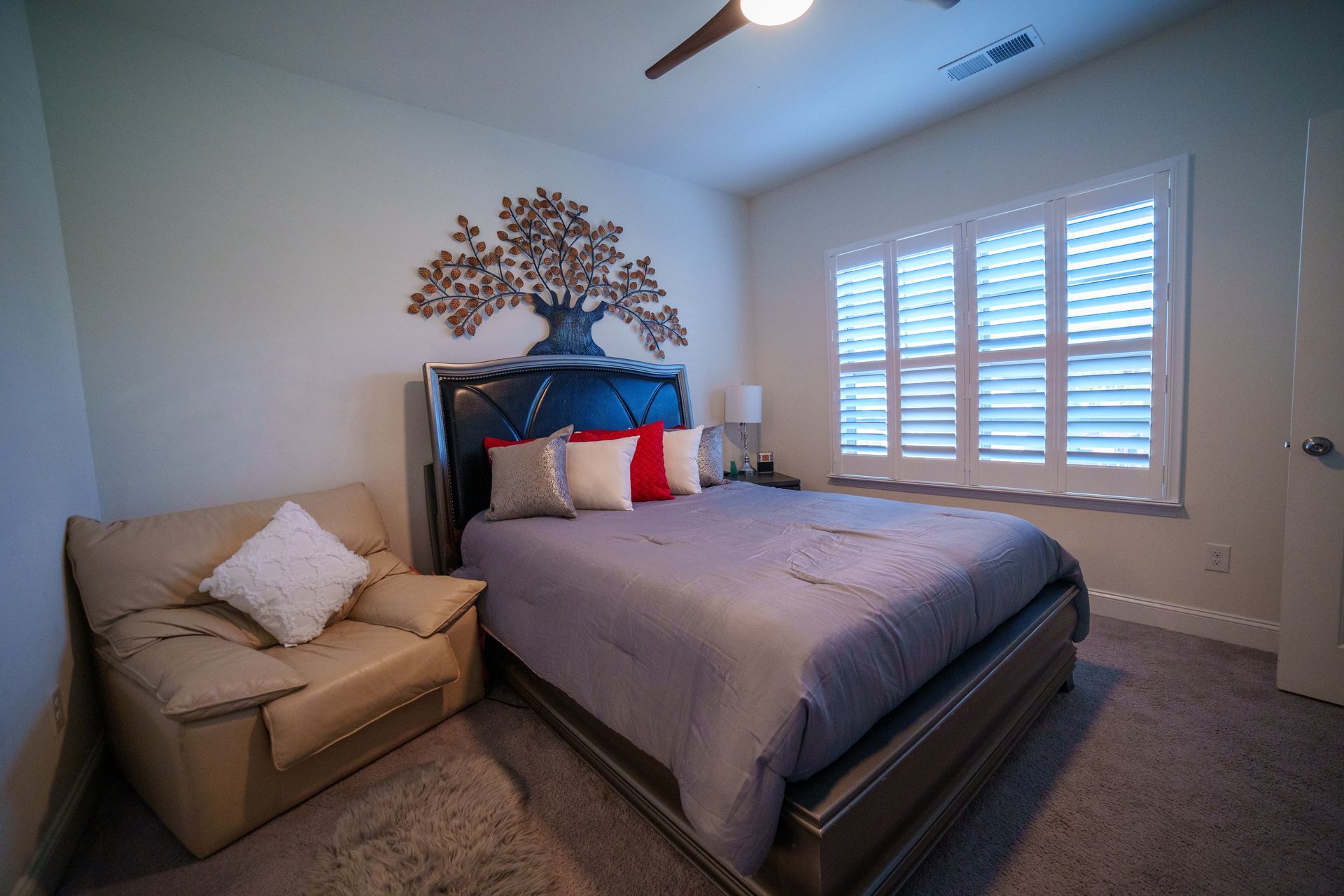 A bedroom with a king size bed and a couch.