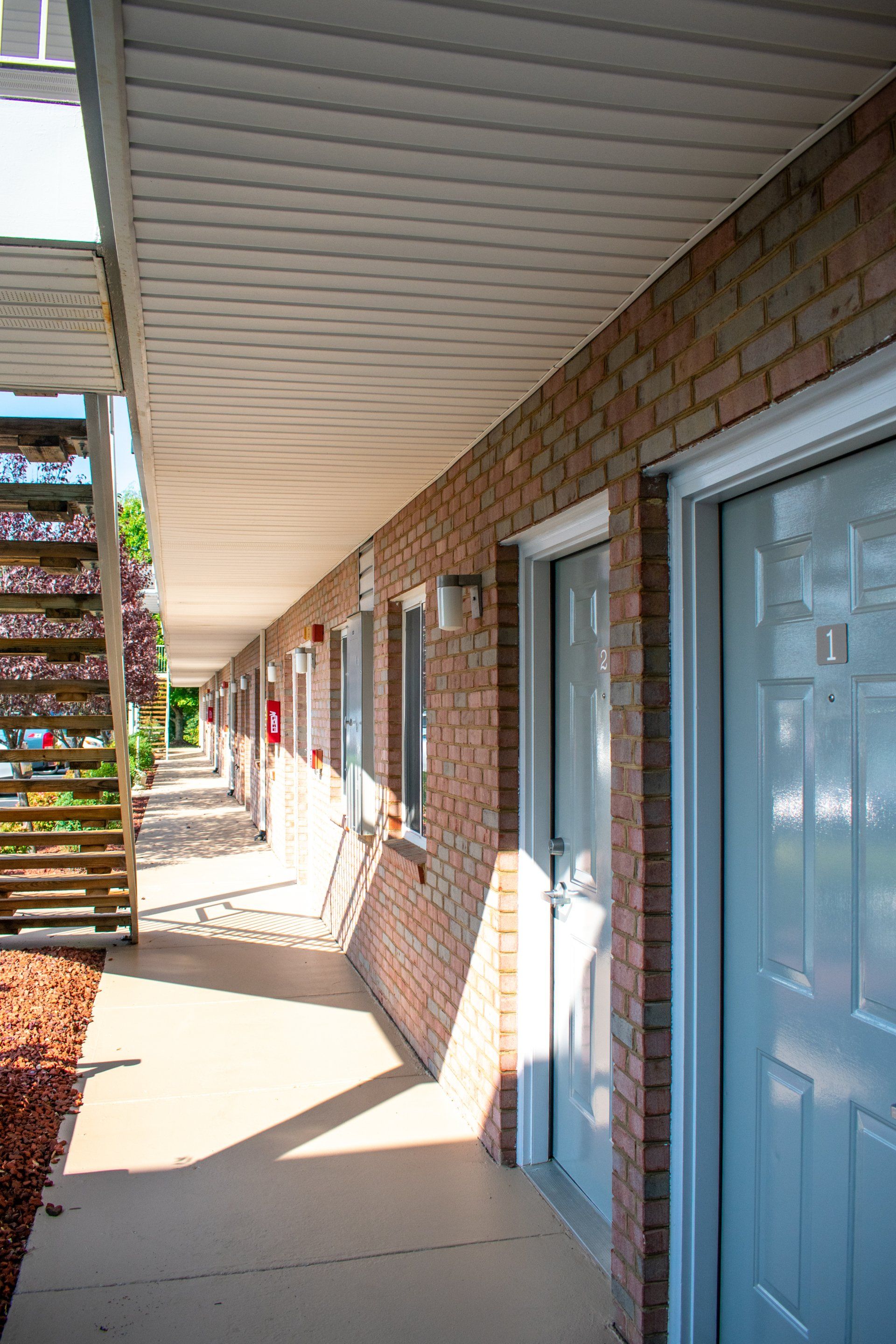 A brick building with a staircase leading up to the second floor.