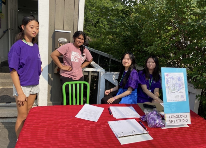 Four young women at a red table promoting 