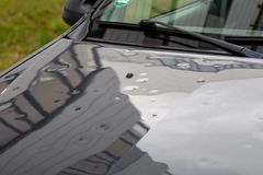 A close up of the hood of a black car