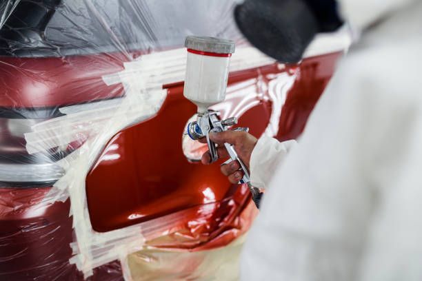 Man With Protective Clothes Painting Car Body Using Spray Compressor - Dover, NJ - Roger Coss Auto Body