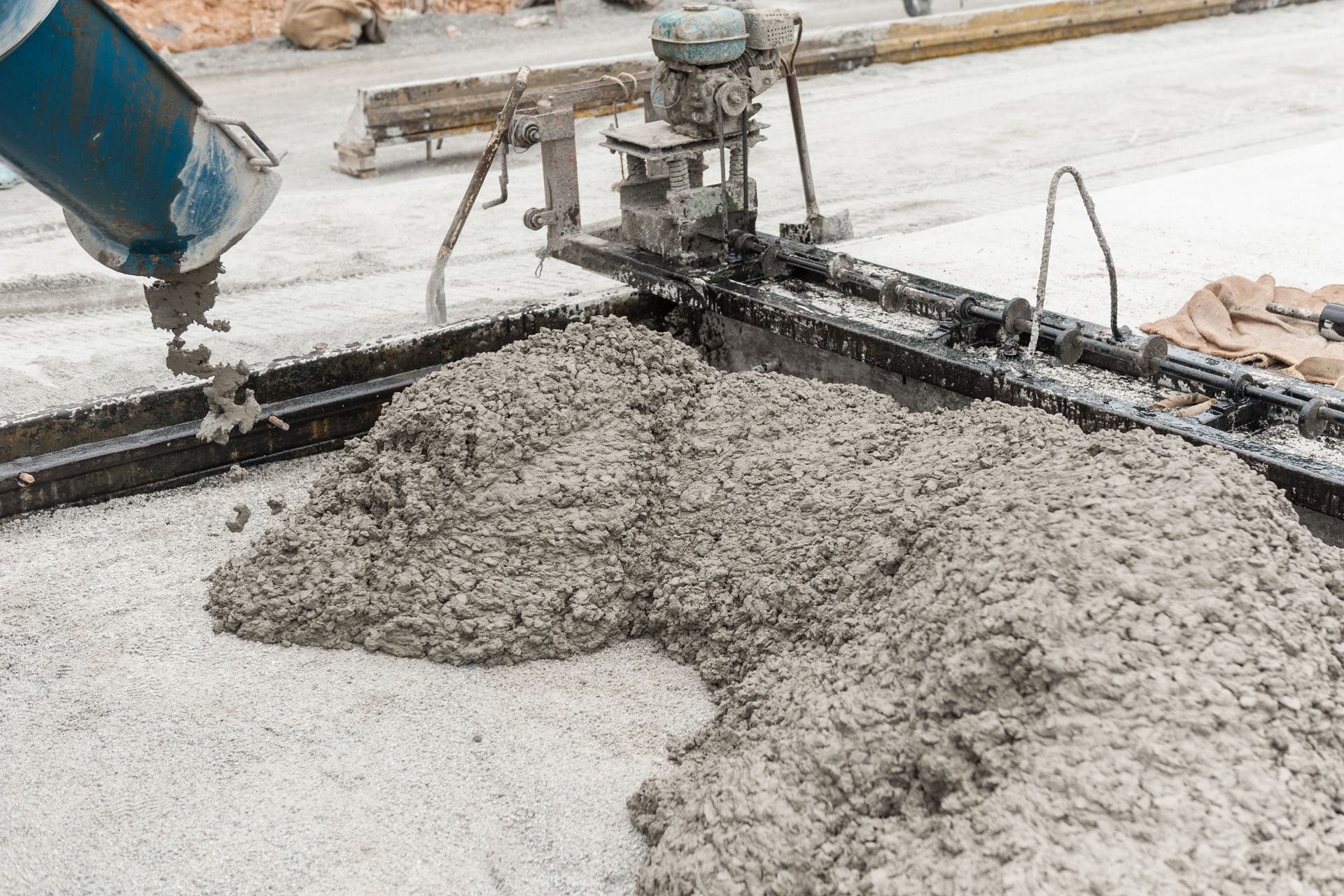 Pouring wet cement during professional ready mix concrete services at a construction site.