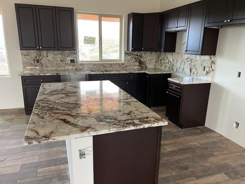 Remodeled kitchen with granite countertops and black cabinets