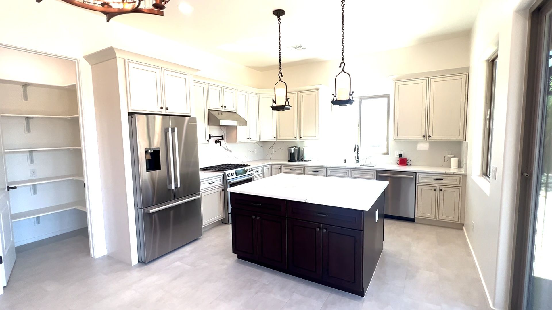 A kitchen with stainless steel appliances and a large island