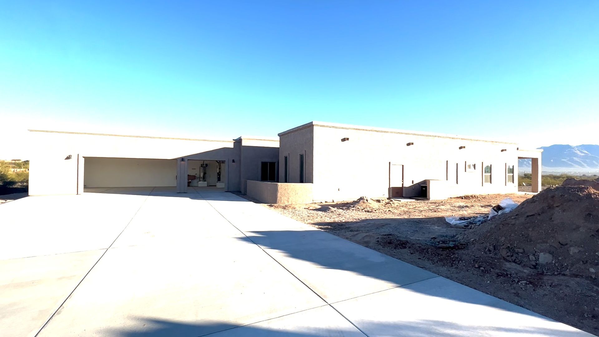 A large house with a concrete driveway leading to it