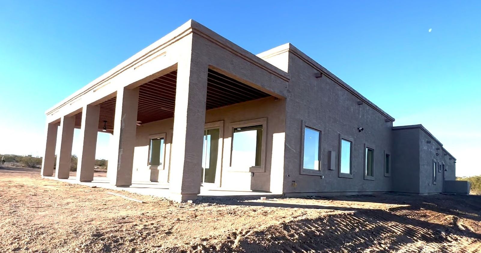 A bathroom with a sink , toilet , mirror and blue door.