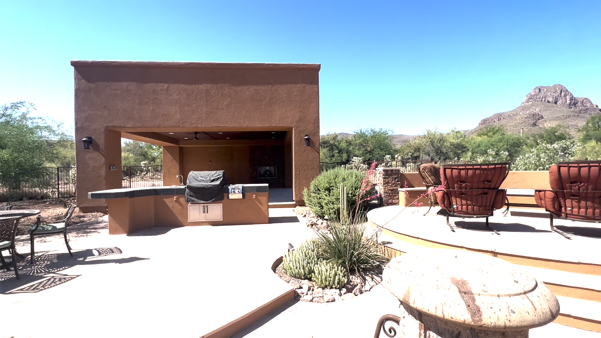 a remodeled outdoor living area with updated landscaping and pavers