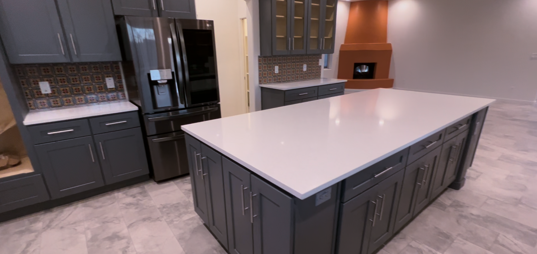 There is a large island in the middle of the kitchen that