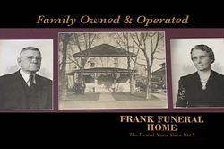 Black and white photo: man and woman on either side of a building.