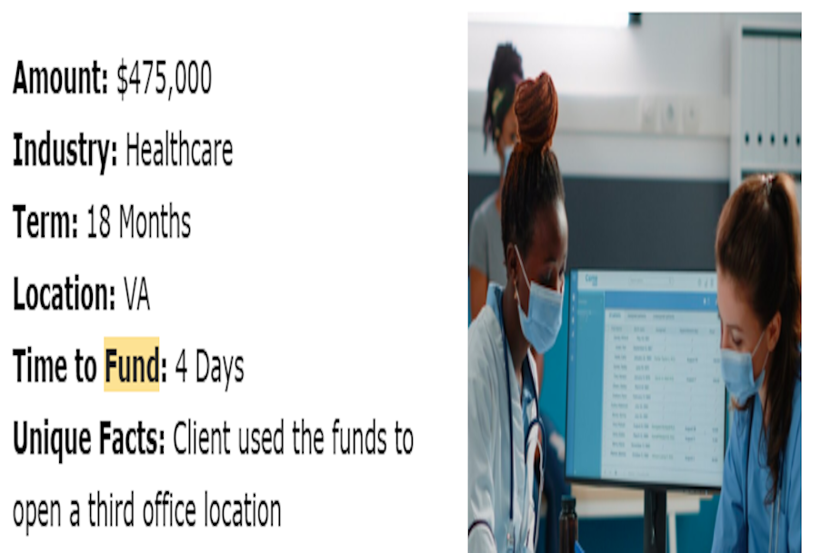 Two doctors wearing face masks are looking at a computer screen