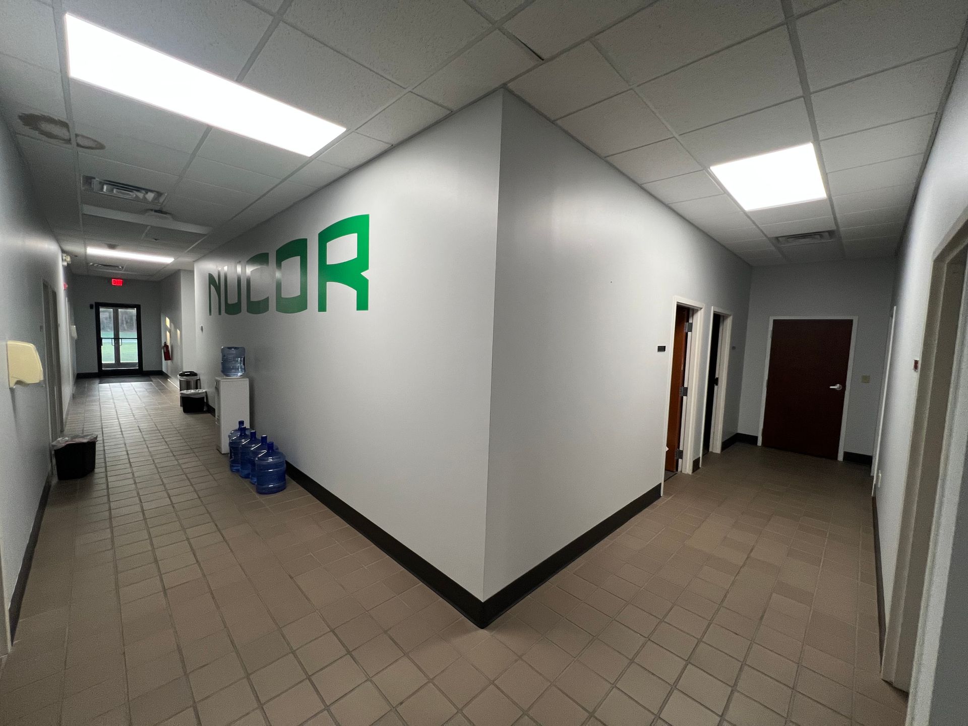 A person is painting a wall with a paint roller.