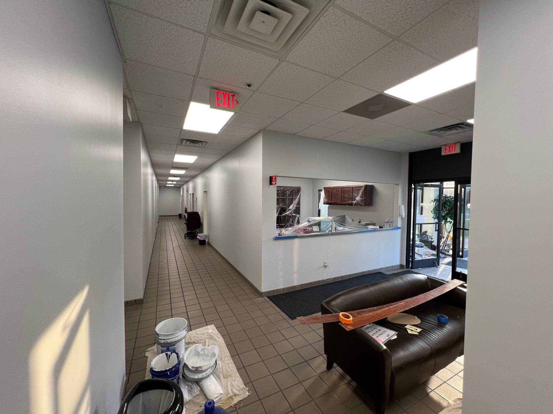 The front door of a house with a stone wall and stairs leading up to it.
