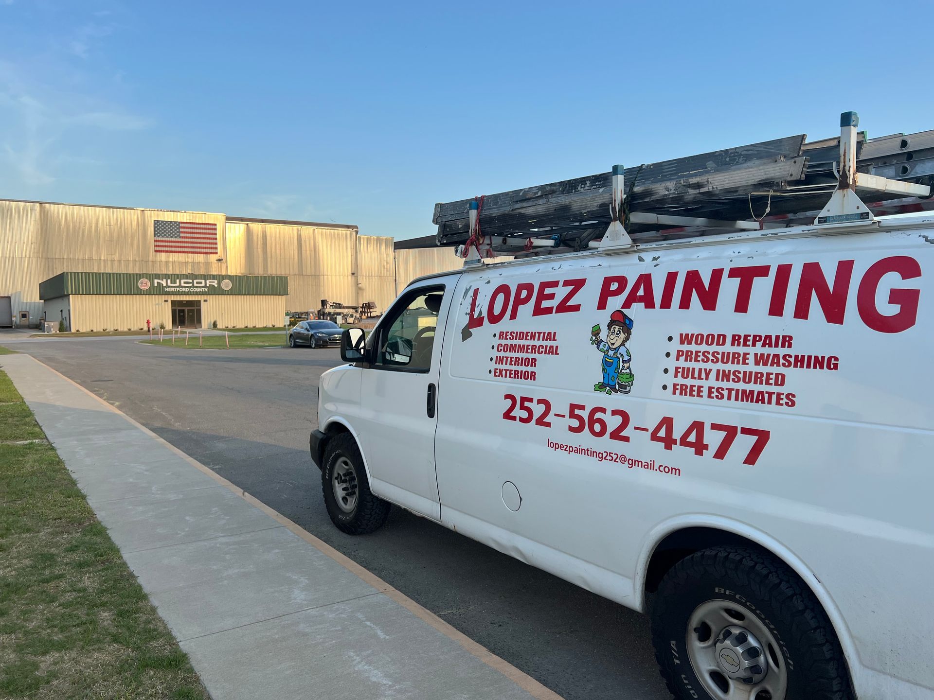 A person is painting a wall with a paint roller.