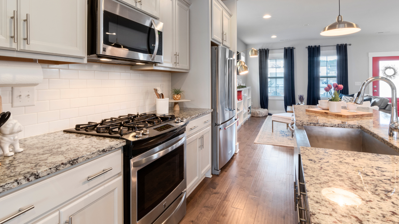 A kitchen with stainless steel appliances and granite counter tops.