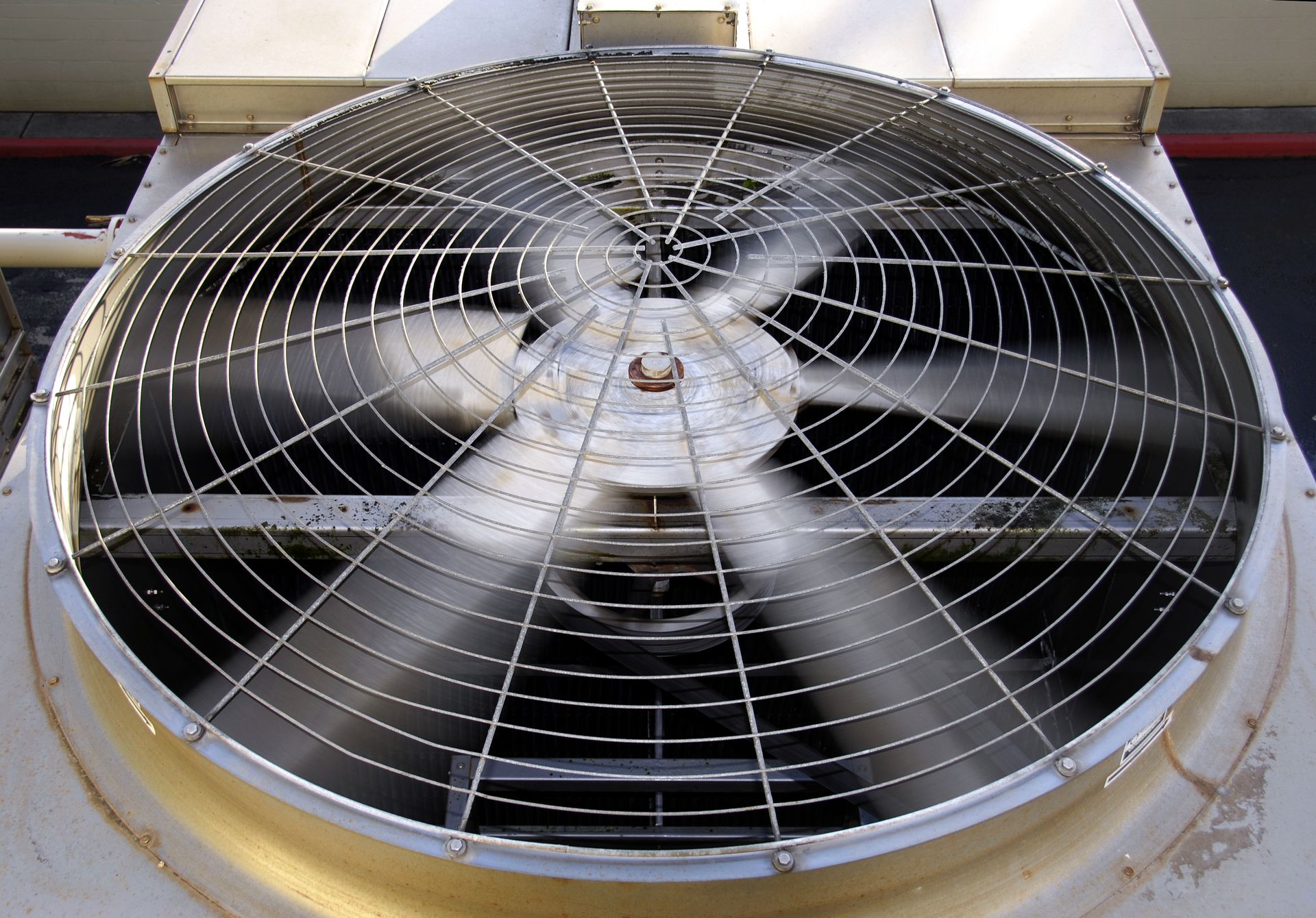 Industrial air conditioning motor with spinning fan, ensuring efficient HVAC cooling. 