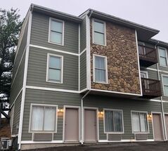 A large apartment building with a lot of windows and doors.