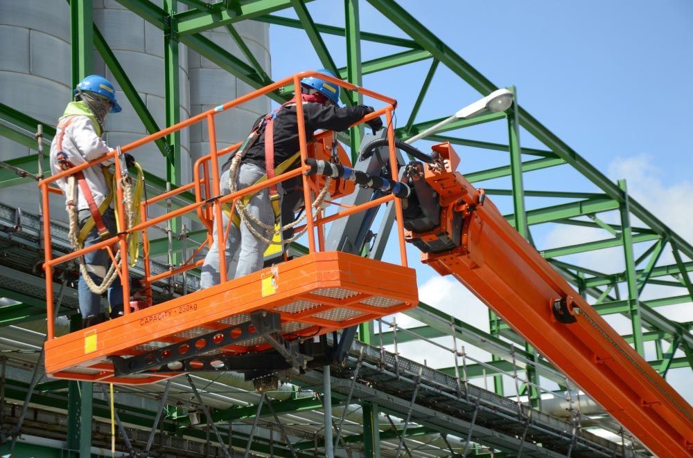 Two Construction Workers Are Working On A Crane — Gympie Crane Hire In Glanmire, QLD