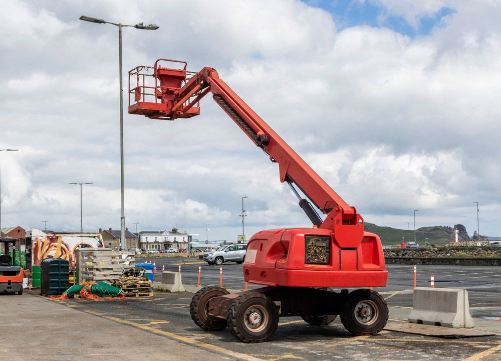 A Red Crane Is Parked In A Parking Lot — Gympie Crane Hire In Glanmire, QLD