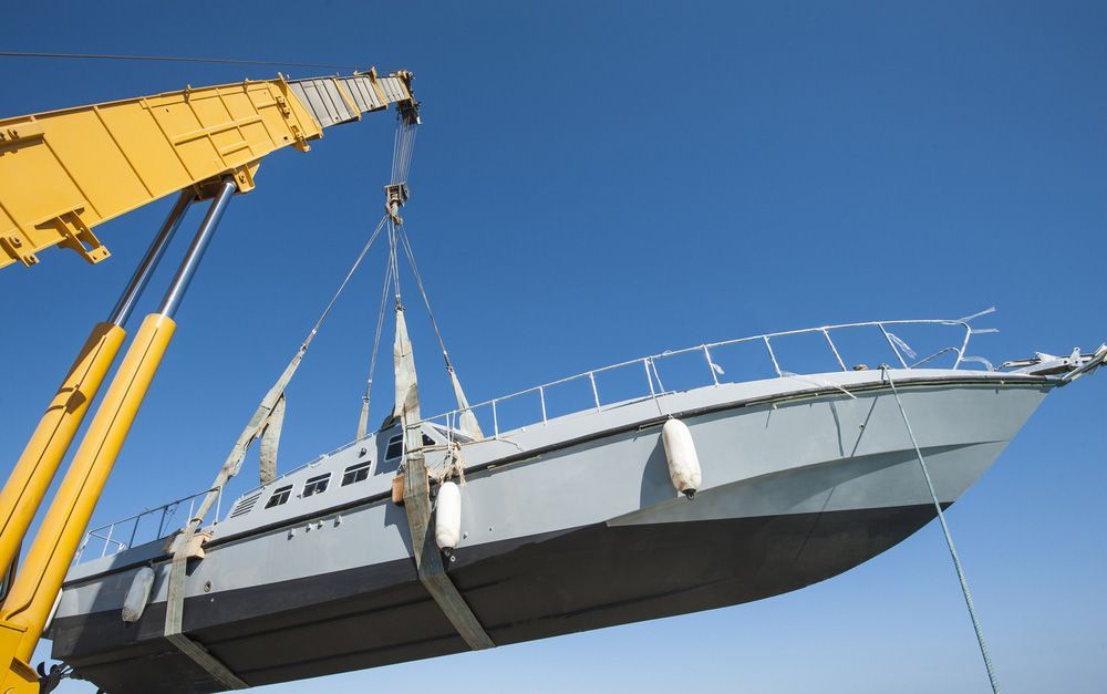 A Boat Is Being Lifted By A Large Yellow Crane — Gympie Crane Hire In Glanmire, QLD