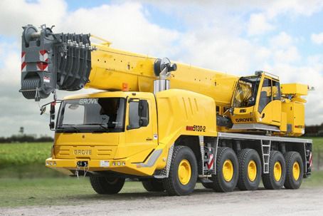 A Large Yellow Crane Truck Is Parked On The Side Of The Road — Gympie Crane Hire In Glanmire, QLD