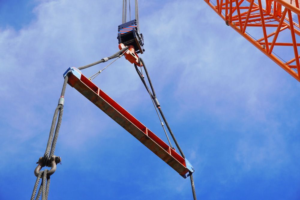 A Crane Is Lifting A Large Piece Of Wood In The Air — Gympie Crane Hire In Glanmire, QLD