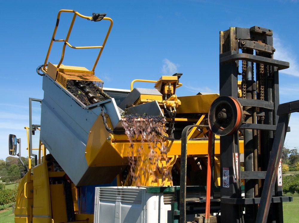 A Forklift Is Attached To A Large Yellow Machine — Gympie Crane Hire In Glanmire, QLD