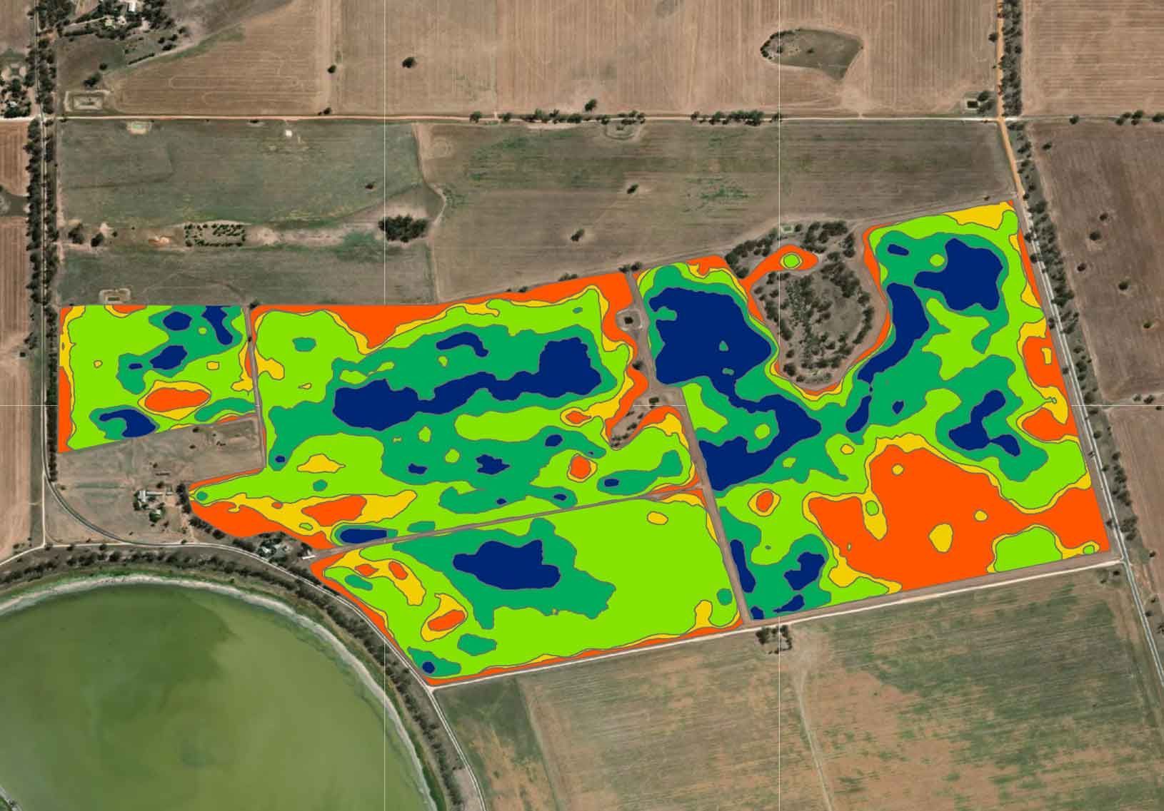 A computer screen shows an aerial view of a field.