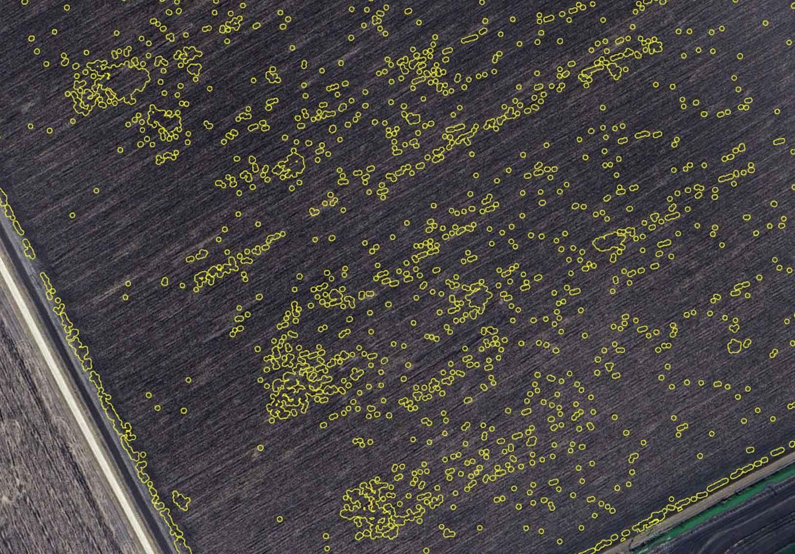 A computer screen shows an aerial view of a field.