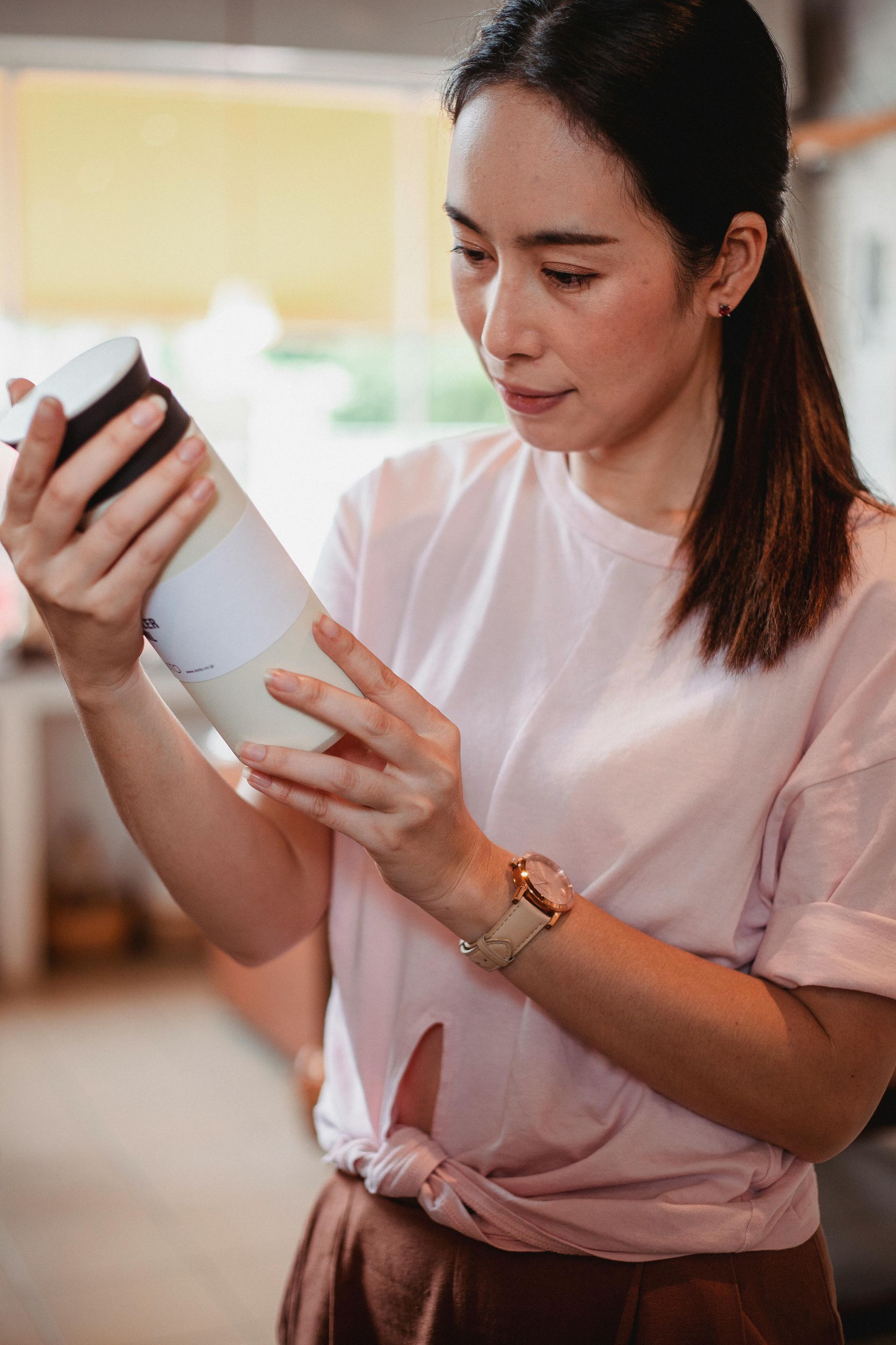 a women looking at the window. She appears to be in deep thought.