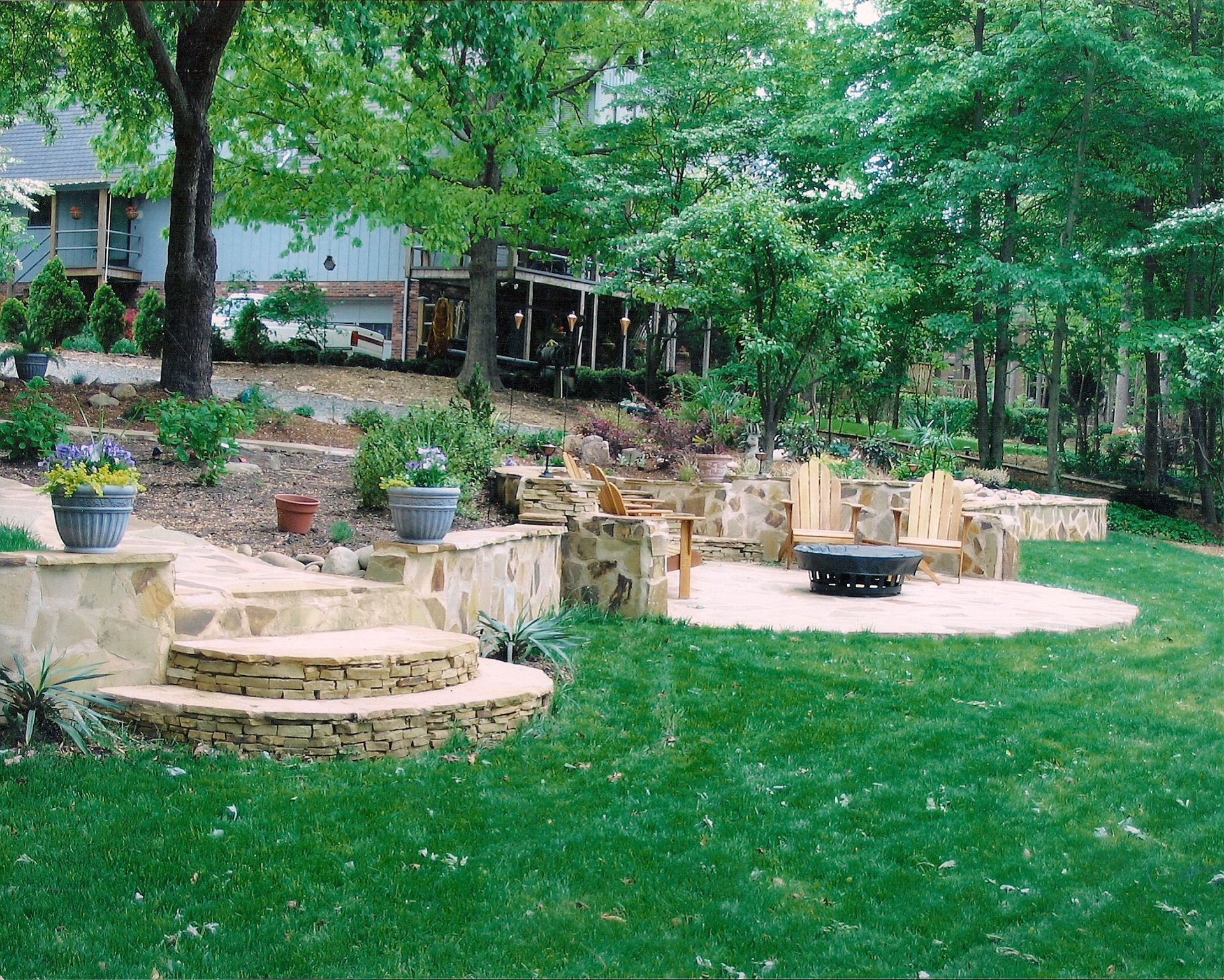 A lush green lawn with a fire pit in the middle