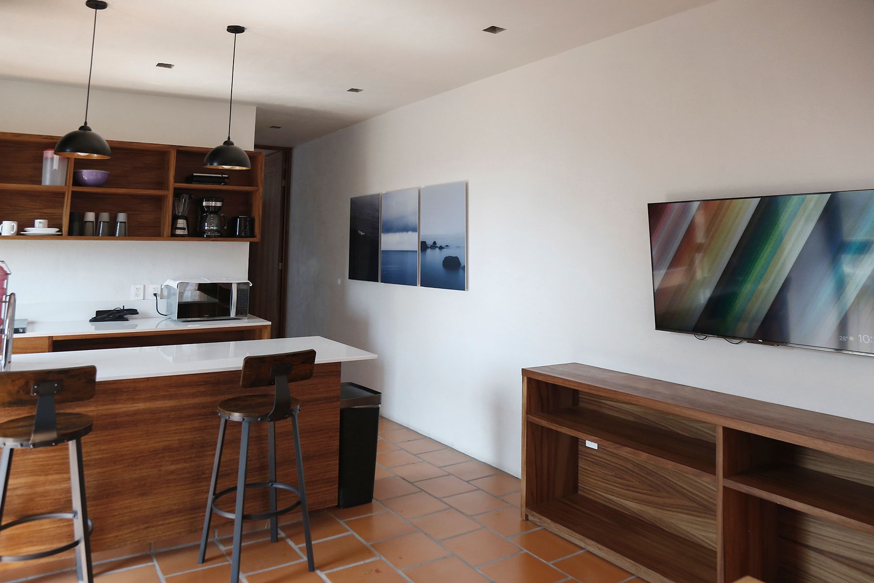 A kitchen with a wooden island and stools