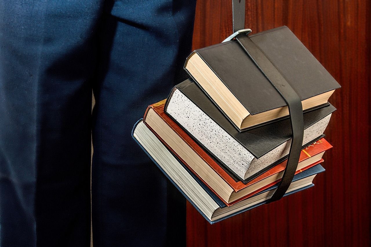 Stack of school books symbolizing back-to-school season and parental leave rights in Colorado