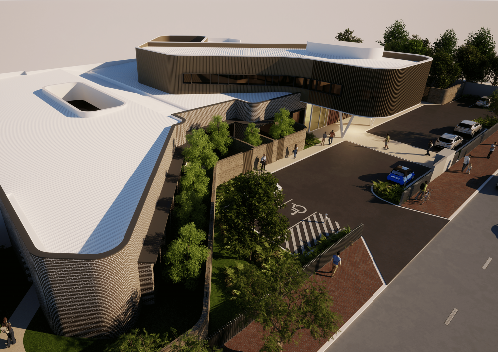 An aerial view of a large building with a handicapped parking spot in front of it.