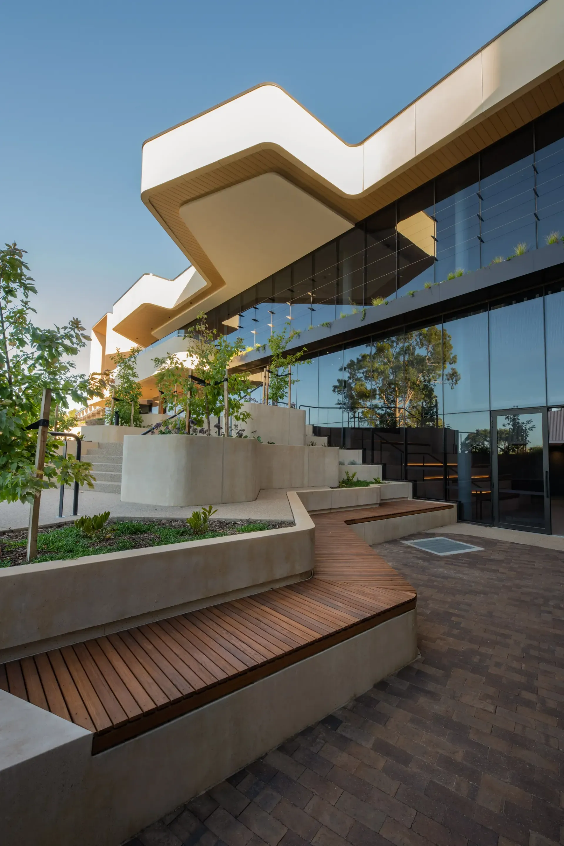 A large building with a wooden bench in front of it.