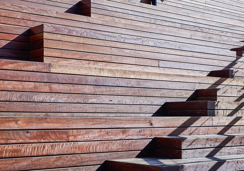 A close up of a wooden wall with stairs leading up to it.