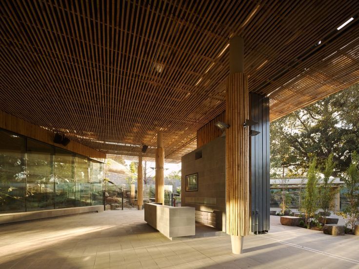 A large room with a wooden ceiling and a reception desk.