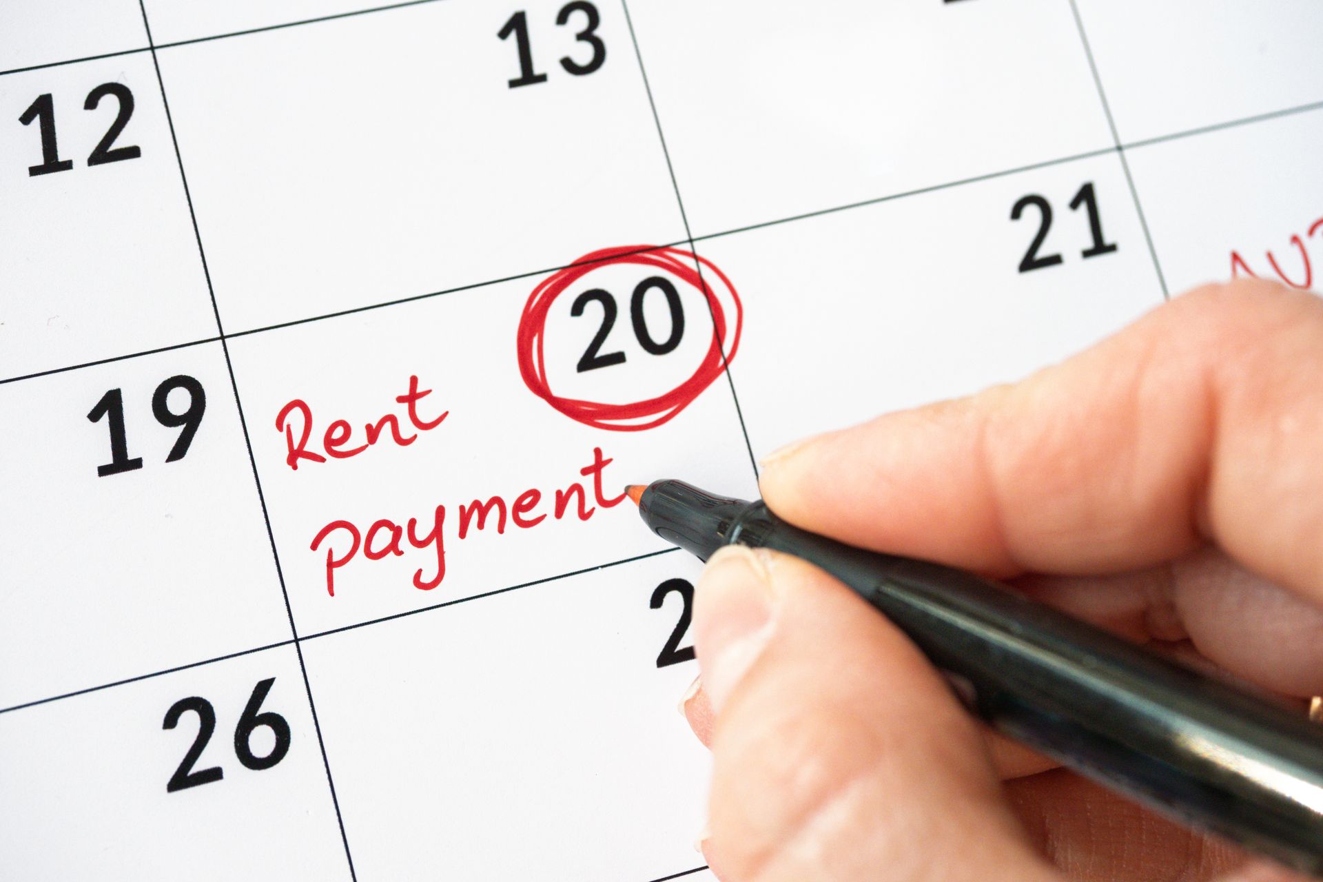 Calendar with a note about rent payment written with red ink pen