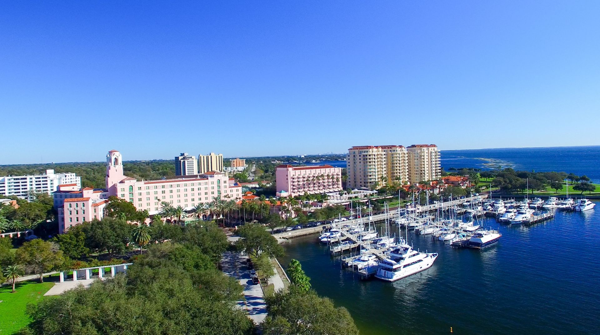 Man looking at computer screen with graphs and charts in an office setting.