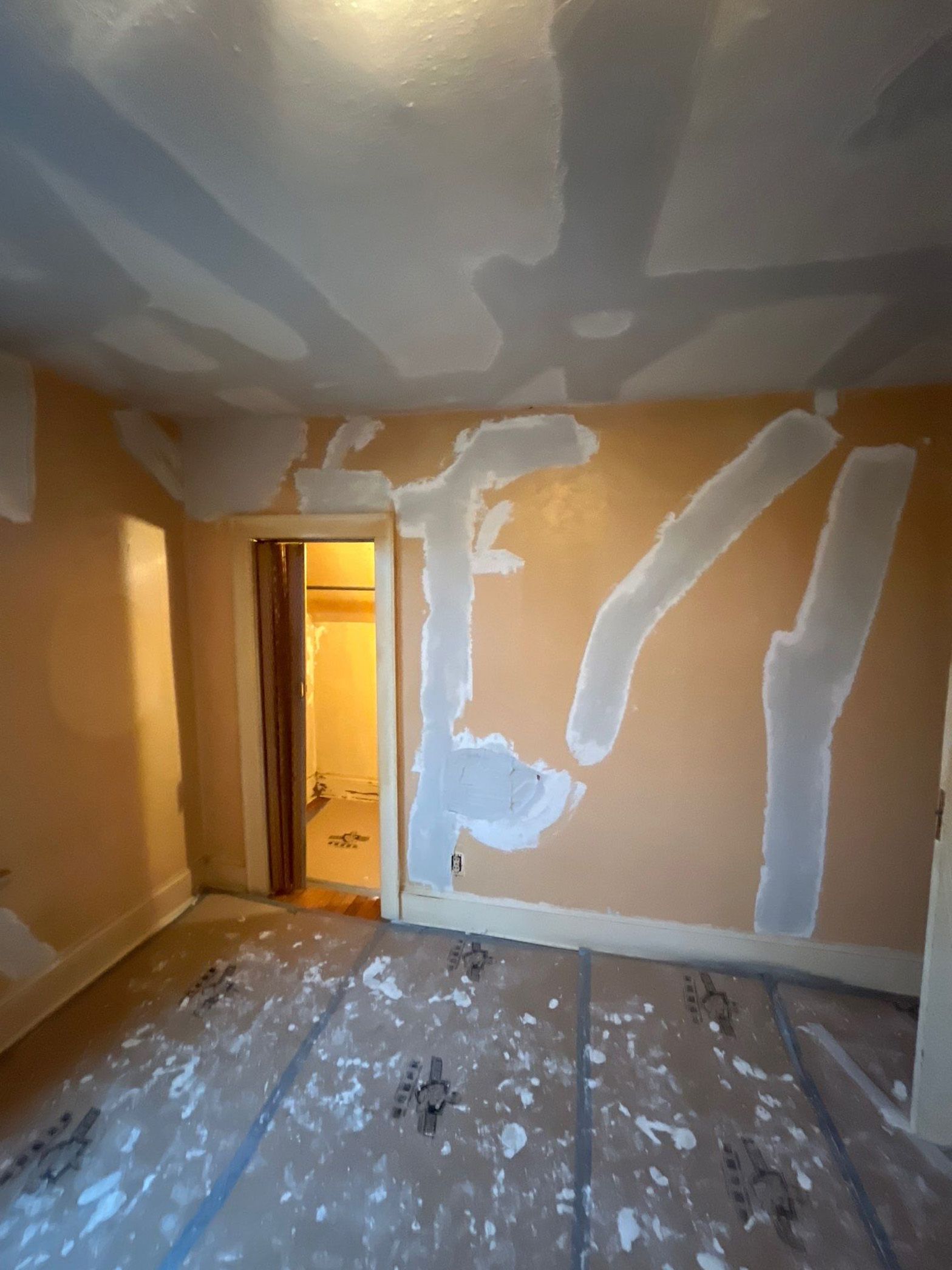 A room with a ceiling that is being painted.