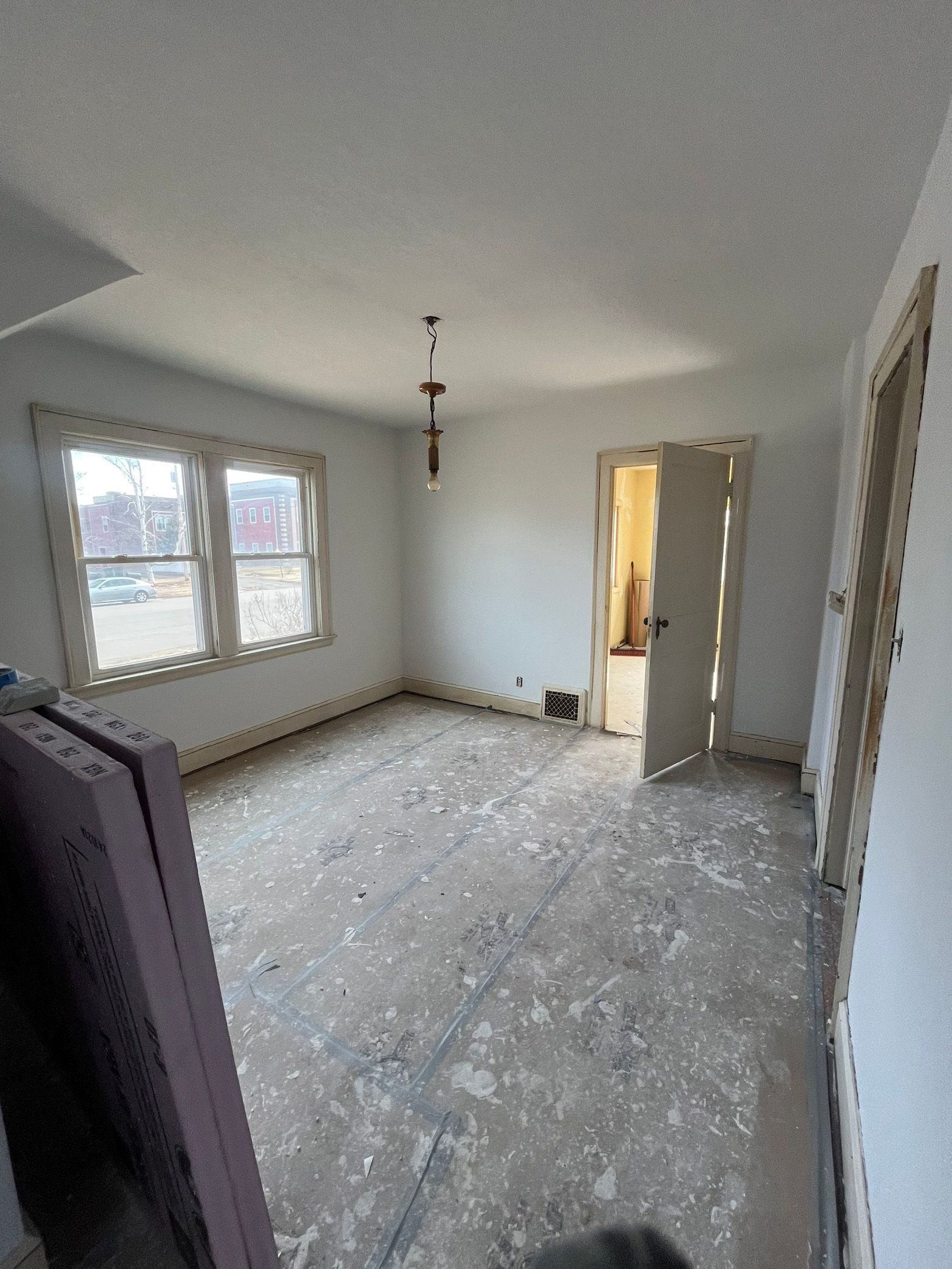 A large empty room with a lot of windows and a door.