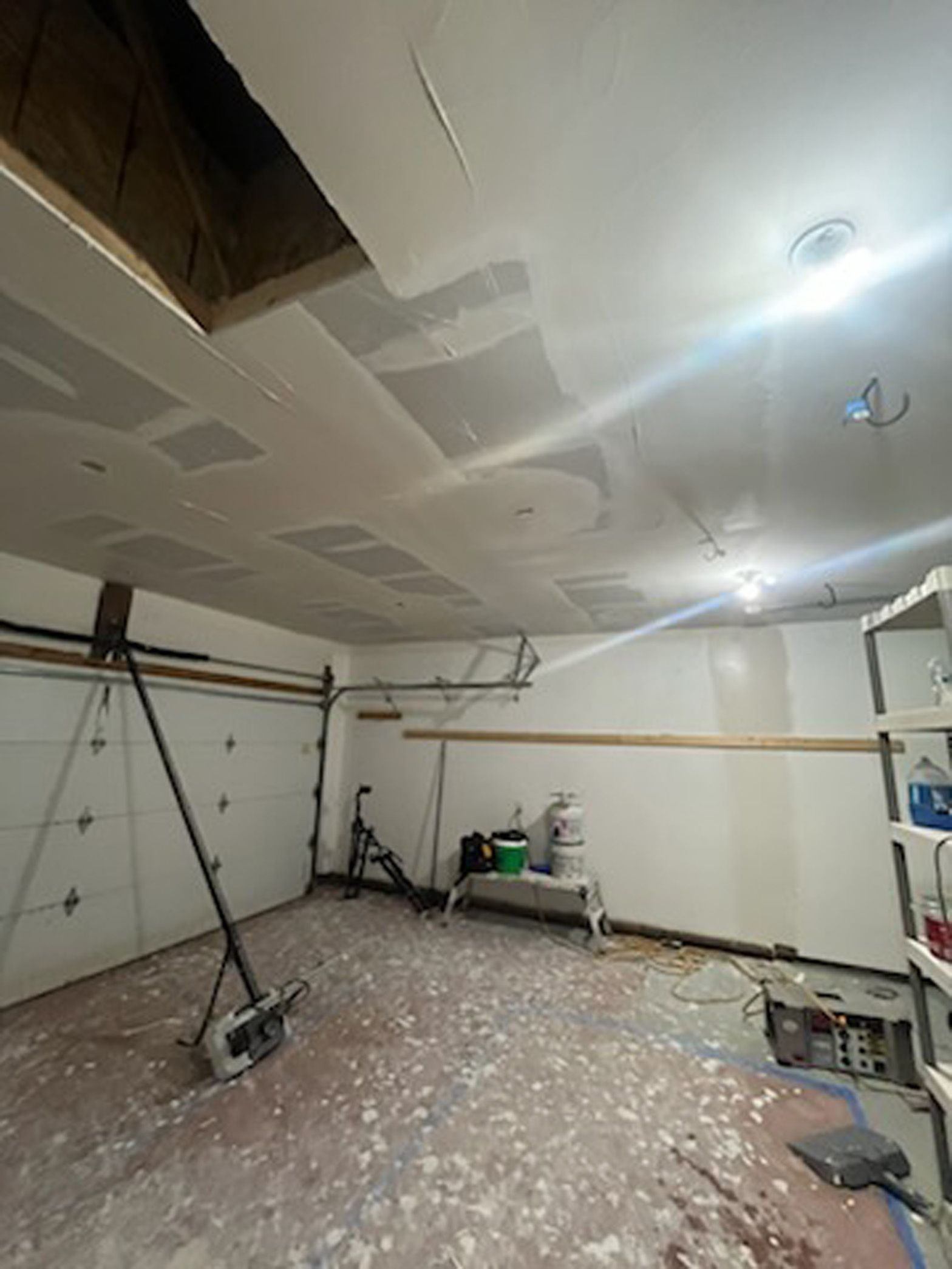 A garage with a ceiling that is being remodeled.