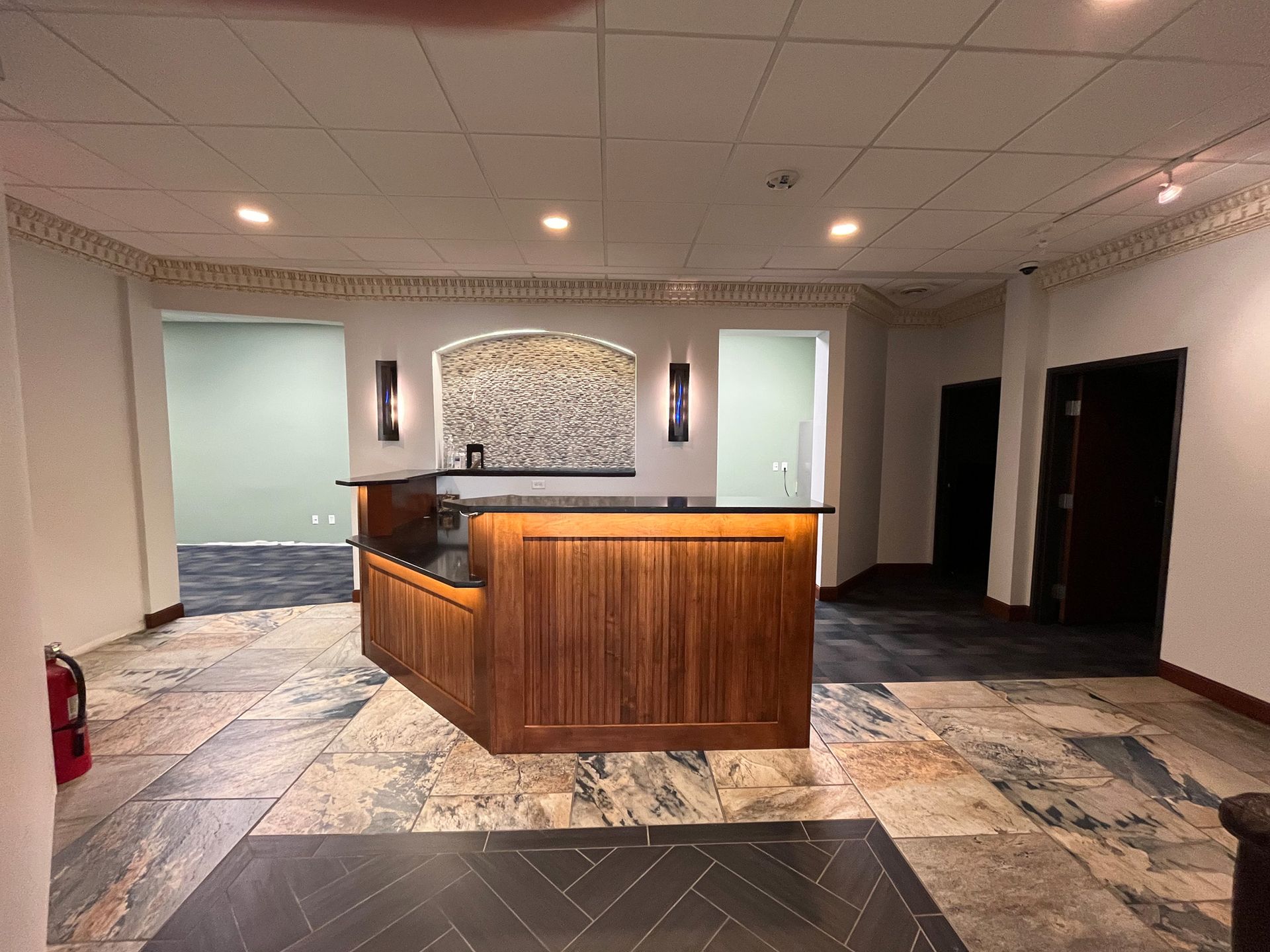 There is a wooden counter in the middle of the room.