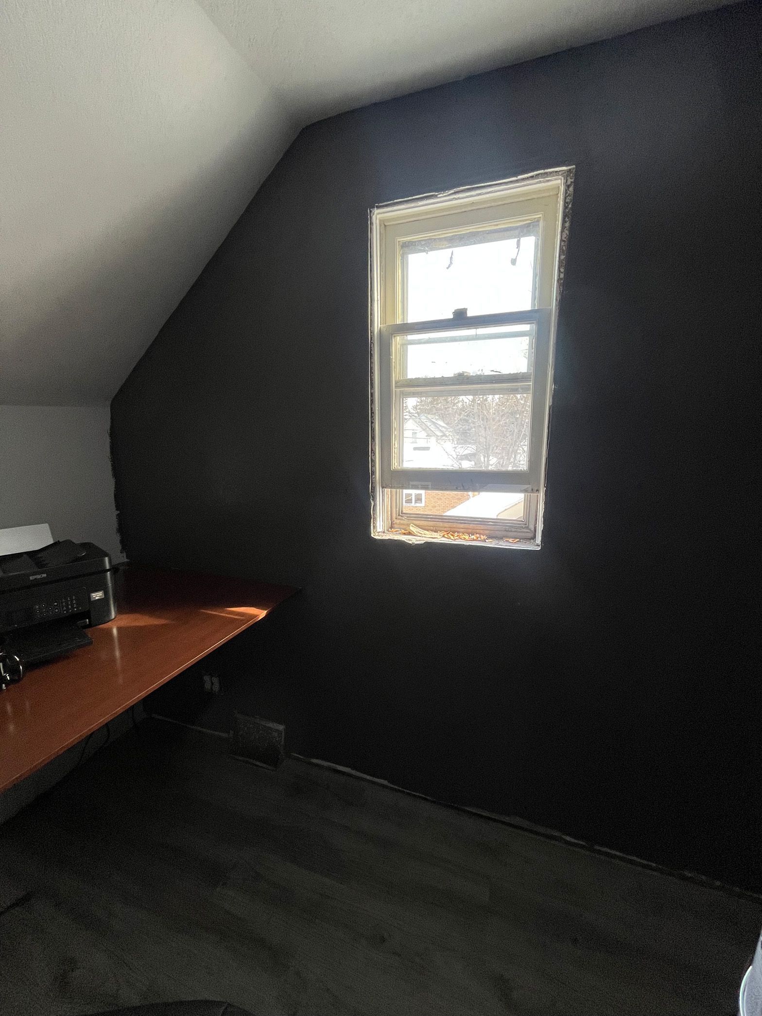 There is a window in the corner of the room.